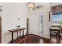 Grand foyer with hardwood floors and a charming decorative table at 6048 Topsail Rd, Lady Lake, FL 32159