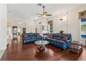 Inviting living room with hardwood floors, comfortable seating, and natural light creating a warm atmosphere at 6048 Topsail Rd, Lady Lake, FL 32159