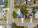 An aerial view shows a home with a pool, solar panels, and a well-maintained street and neighborhood at 6221 Ambassador Dr, Orlando, FL 32808