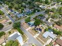 Birds-eye view of a residential neighborhood featuring houses with pools, solar panels, and tree-lined streets at 6221 Ambassador Dr, Orlando, FL 32808