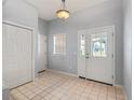 Bright foyer featuring tile floors, double front doors, and a convenient coat closet at 628 San Pedro Dr, The Villages, FL 32159