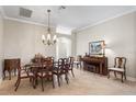 Elegant dining room with tile flooring, chandelier, and comfortable seating at 654 Poinsett Ct, The Villages, FL 32162