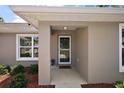 Inviting front entry featuring a covered porch, neutral paint, and manicured landscaping at 7162 Se 124Th St, Belleview, FL 34420