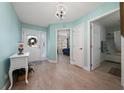 Inviting foyer with a view into the bedroom and bathroom with luxury vinyl plank flooring at 9430 Se 176Th Saffold St, The Villages, FL 32162