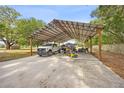 Carport with a metal roof, concrete floor and covered parking for multiple vehicles at 9483 Cr 747, Webster, FL 33597
