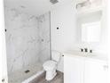 Stylish bathroom features a marble-tiled shower, modern fixtures, and a sleek vanity with ample storage at Lot 21 Indian Estates Cr 423, Lake Panasoffkee, FL 33538