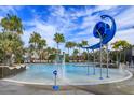 Community splash pool with water features surrounded by tropical palm trees at 10114 Ballast Dr, Orlando, FL 32827