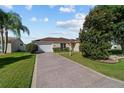 Lovely single-story home with a well-manicured lawn and spacious driveway at 1014 Nash Loop, The Villages, FL 32162