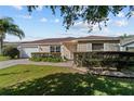 Beautiful single-story home featuring a well-maintained lawn and tidy landscaping at 1014 Nash Loop, The Villages, FL 32162