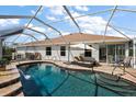 Spacious screened-in pool featuring a waterfall, ample seating, and access to the home's interior at 1175 Johnston Path, The Villages, FL 32162