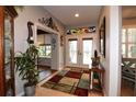 Bright foyer with tile flooring, decorative glass, and arched doorway leads to living spaces at 11868 Se 91St Cir, Summerfield, FL 34491