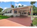 This house has a convenient carport and well-manicured landscaping at 124A Shady Ln, Eustis, FL 32726