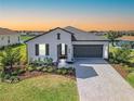 Well-maintained single-Gathering home with gray roof, brick driveway, and manicured landscaping at 17108 Se 111Th Terrace Rd, Summerfield, FL 34491