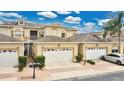 Well-kept townhome exterior with a two-car garage, manicured shrubs, and a neatly paved driveway at 17406 Chateau Pine Way, Clermont, FL 34711
