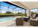 Relaxing screened-in pool area with an outdoor lounge, dining set, and stunning golf course views at 17700 Sawgrass Run, Tavares, FL 32778