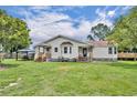 A charming home with a large backyard and mature trees provides a serene outdoor living space at 21320 Paradise Way, Eustis, FL 32736