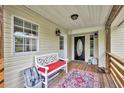 Charming front porch with cozy seating area, perfect for enjoying the outdoors at 21320 Paradise Way, Eustis, FL 32736