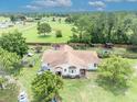 Charming home featuring a well-manicured lawn and rear exterior, perfect for outdoor enjoyment and relaxation at 21320 Paradise Way, Eustis, FL 32736