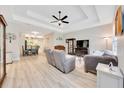 Spacious living room with modern ceiling fan, plush seating, and wood-look flooring at 2163 County Road 243F, Wildwood, FL 34785