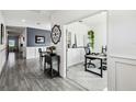 Hallway leading into an office space, neutral colors, with wainscoting and wood-look tile at 2350 Gold Dust Dr, Clermont, FL 34715