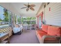 Relaxing screened-in porch with comfortable seating and ceiling fan at 2475 Karen Dr, Mount Dora, FL 32757