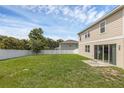 Expansive fenced backyard with lush green grass, perfect for outdoor activities and relaxation at 2532 Autumn Stream Dr, Leesburg, FL 34748
