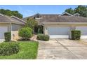 Charming townhome with attached garage, tidy landscaping, and a welcoming facade at 264 Juniper Way, Tavares, FL 32778