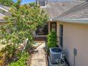 Inviting front porch with vibrant flowering tree and relaxing rocking chair at 264 Juniper Way, Tavares, FL 32778