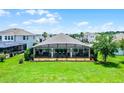 Expansive backyard with a large screened-in lanai, perfect for outdoor entertaining and enjoying the beautiful scenery at 313 Blue Cypress Dr, Groveland, FL 34736