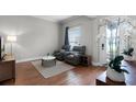 Cozy living room featuring wood floors, two chairs and bright lighting at 313 Blue Cypress Dr, Groveland, FL 34736