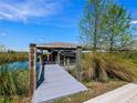 Private dock boasts a covered boat lift, providing convenient access to the serene waterway at 395 Blue Cypress Dr, Groveland, FL 34736