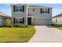 Charming two-story home features a well-maintained lawn, gray exterior, and attached two-car garage at 4713 Sw 86 Ln, Ocala, FL 34476