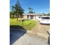 Charming single-story brick home with well-manicured lawn and mature landscaping at 48 Pinehurst Cir, Ormond Beach, FL 32174