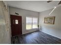 Inviting entryway boasts modern dark wood-look floors, a window, and a solid wood front door at 504 Se 35Th Ave, Ocala, FL 34471