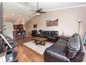 Cozy living room featuring hardwood floors, a ceiling fan, and comfortable leather sofas at 5437 Compass Pt # 00, Oxford, FL 34484