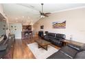 Inviting living room with hardwood floors, a ceiling fan, and an open layout connecting to the kitchen at 5437 Compass Pt # 00, Oxford, FL 34484