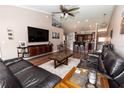 Spacious living room with hardwood floors, a ceiling fan, and an open floor plan leading to the kitchen at 5437 Compass Pt # 00, Oxford, FL 34484