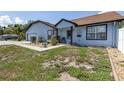 Exterior shot of home featuring light blue paint and simple desert landscaping at 5521 Oak St, Mount Dora, FL 32757
