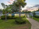 Charming home with a well-manicured lawn and tropical landscaping at 727 Turnberry Ln, The Villages, FL 32159