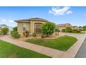 Beautifully landscaped corner lot with lush green grass and meticulously arranged plants and shrubbery at 832 Parrish Pl, The Villages, FL 32163