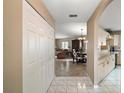 View of foyer flowing into the living room, dining area, and kitchen of the home at 8639 Se 141St Pl, Summerfield, FL 34491