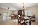 Bright living room with tile flooring, ceiling fan, and sliding glass doors at 8639 Se 141St Pl, Summerfield, FL 34491