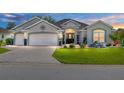 Charming single-story home with a well-manicured lawn and paved driveway at 9059 Se 177Th Grassmere St, The Villages, FL 32162