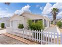Single-story home featuring a manicured lawn, white picket fence, and a well-kept facade at 9321 Se 172Nd Augusta Ln, The Villages, FL 32162