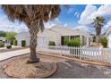 Quaint single-Gathering home featuring mature landscaping and a charming white picket fence at 9321 Se 172Nd Augusta Ln, The Villages, FL 32162