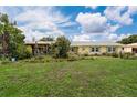 Inviting yellow home with lush landscaping and charming gazebo, perfect for outdoor entertaining at 101 Lakeshore Blvd, St Cloud, FL 34769