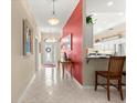 Bright foyer boasts tile flooring, decorative lighting, and an accent wall for a grand entrance at 1010 Sierra Blanca Ct, Lady Lake, FL 32159
