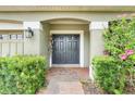 Inviting double front doors with lush landscaping, enhancing curb appeal at 107 Wekiva Pointe Cir, Apopka, FL 32712