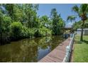 Lakeside dock featuring a boat lift and space for relaxing by the water at 11418 Lake Eustis Dr, Leesburg, FL 34788