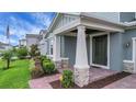 Charming front porch with stone accents, manicured landscaping, and a brick pathway leading to the entrance at 14501 Wabasso Loop, Winter Garden, FL 34787